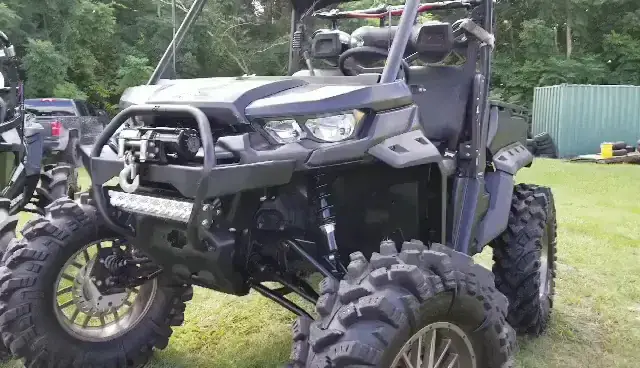A lifted side-by-side with a winch, front bumper and LED light bar built at TMT Offroad in Williston, FL