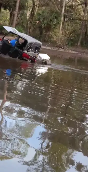 A side-by-side crossing deep water on a north Florida trail, the riding TMT Offroad snorkel kits are built for